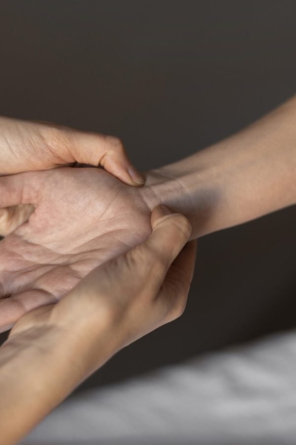 close-up-hands-massaging-wrist